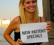 woman holding new patient special sign