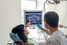 emergency dentist showing a patient their X-rays